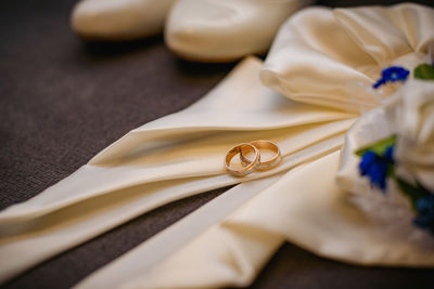 Close-up of gold colored pencils on table