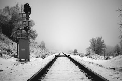 Railroad tracks against clear sky during winter