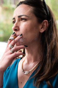 Close-up of thoughtful woman smoking cigarette
