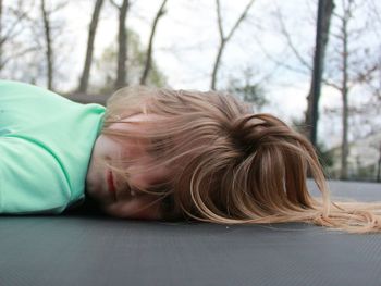 Portrait of girl lying on surface