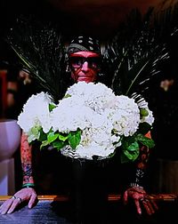 Full length of man holding white flowering plant