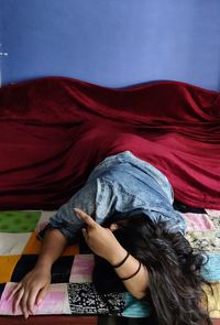 Midsection of woman lying on bed