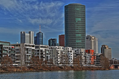 Skyscrapers in city against blue sky