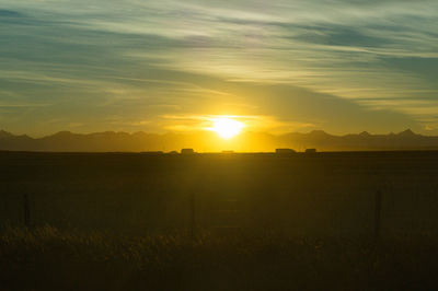 Scenic view of field against sky during sunset