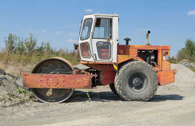 Tractor on field against sky