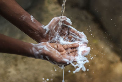 Close-up of person splashing water