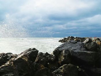 Scenic view of sea against cloudy sky