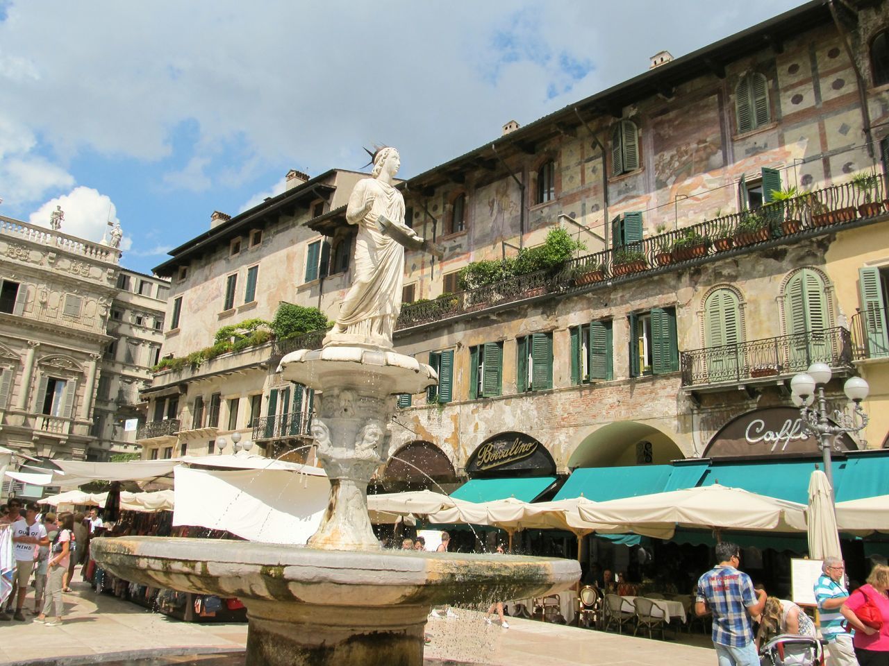 architecture, building exterior, built structure, large group of people, sky, statue, sculpture, men, city, incidental people, water, person, art and craft, art, tourist, travel destinations, human representation, town square, tourism