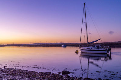 Sailboats in marina at sunset