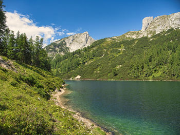 Scenic view of mountains against blue sky