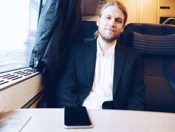 Portrait of businessman traveling in train