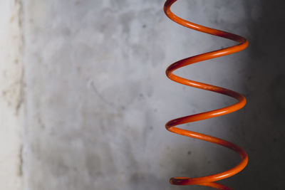 Close-up of spiral wire against wall