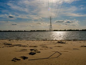 Scenic view of beach against sky during sunset