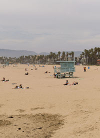 People on beach against sky