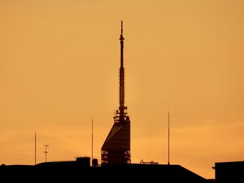 Silhouette of building against sky during sunset