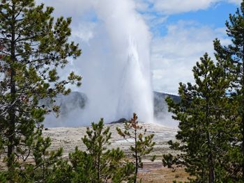 Scenic view of waterfall against sky