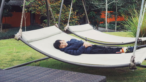 Portrait of boy lying on hammock