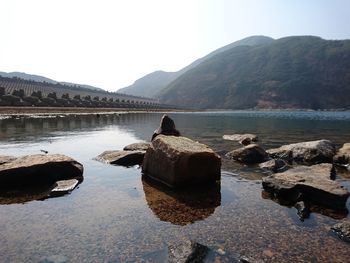 Scenic view of lake and mountains against sky