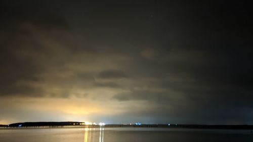 Scenic view of sea against sky at night