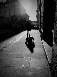 Silhouette of man on street in city