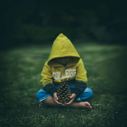 Boy sitting on field