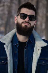 Portrait of man wearing sunglasses standing outdoors