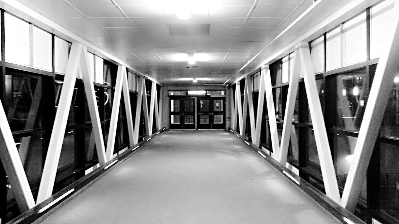 indoors, architecture, built structure, the way forward, corridor, diminishing perspective, empty, ceiling, building, window, vanishing point, absence, modern, narrow, glass - material, reflection, long, in a row, no people, interior