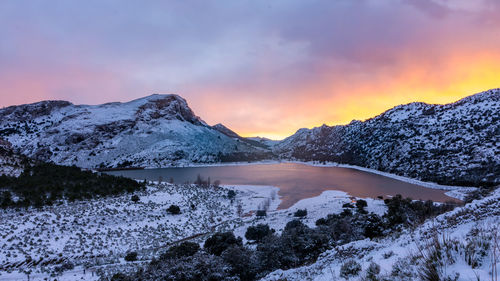 Scenic view of snowcapped mountains against sky during sunset