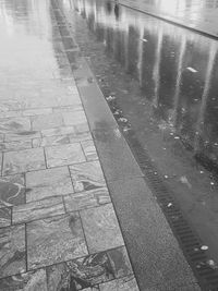 High angle view of raindrops on puddle