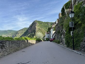 Road amidst mountain against sky