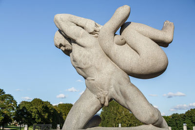 Low angle view of statue against blue sky