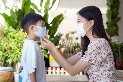 Mother wearing mask to son