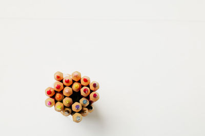 Directly above shot of multi colored candies against white background