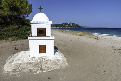 Possidi, greece, july 21, 2023. small white chapel on possidi beach.