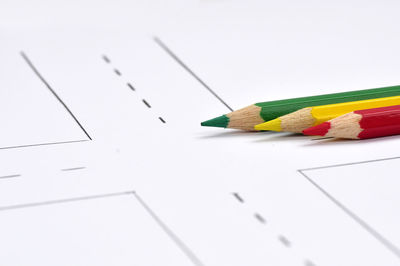 High angle view of colored pencils on white background