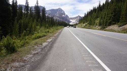 Empty road along countryside landscape