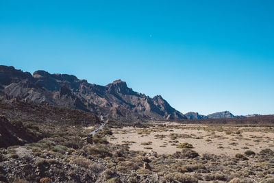 Scenic view of rocky mountains against clear blue sky