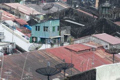 High angle view of antennas on house roof