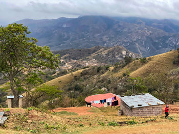 Scenic view of landscape and houses against mountains