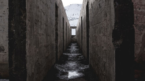 Road amidst snow covered mountains against sky