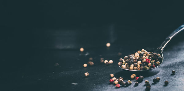 Close-up of peppercorns in spoon on table