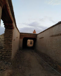 Corridor of historic building against sky