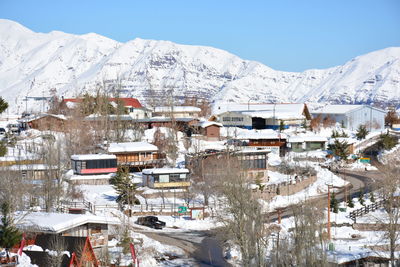 Aerial view of snow covered houses in town