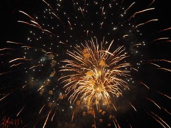 Low angle view of firework display at night