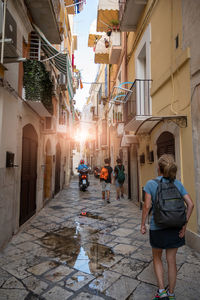 Rear view of woman walking on street in city