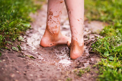 Low section of woman standing on ground