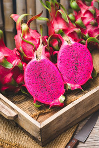 Close-up of pink fruits on table at market stall