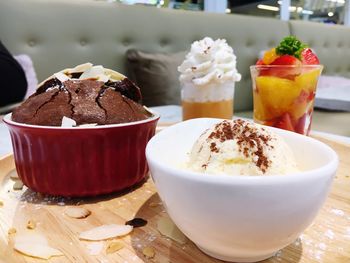 Close-up of ice cream in bowls on messy table