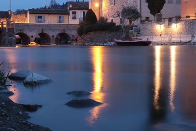 Reflection of illuminated buildings in water at night