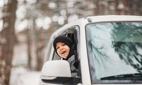 Portrait of smiling boy in car